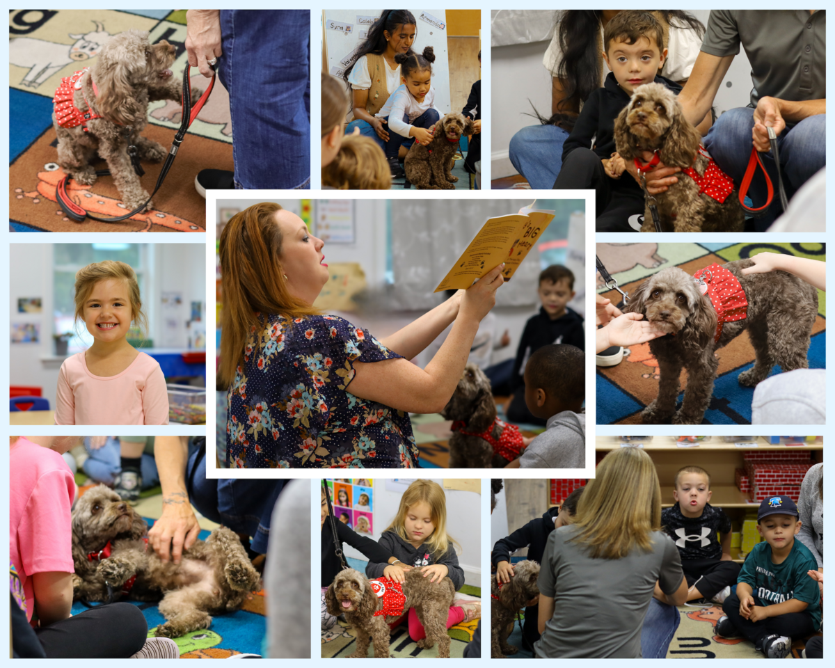 A woman reads a book to a group of children and a dog in a classroom.