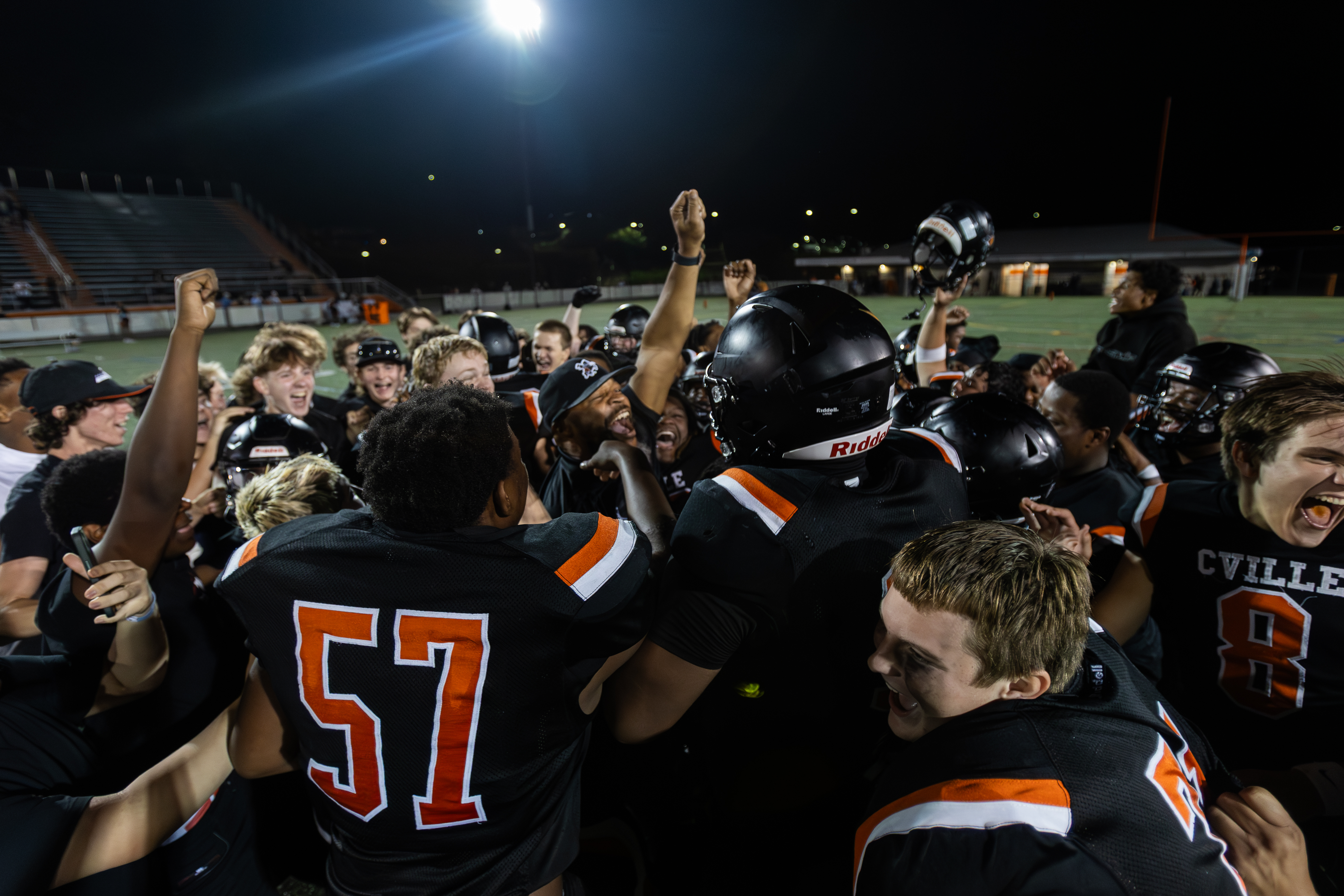 Charlottesville High School football coach Terrell Mulford raises his fist in the air in celebration after the Black Knights earned their first victory of the 2025 season.