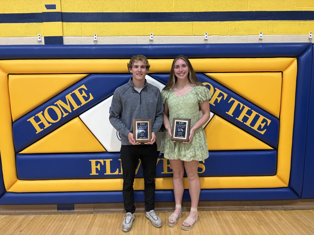 Two student athletes, Jack Kriegl and Cassie Olson, proudly hold their "Senior Athlete of the Year" awards.