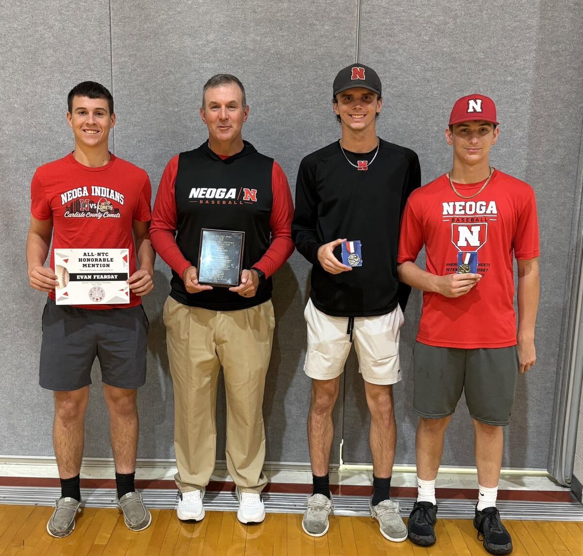 male award winners holding plagues