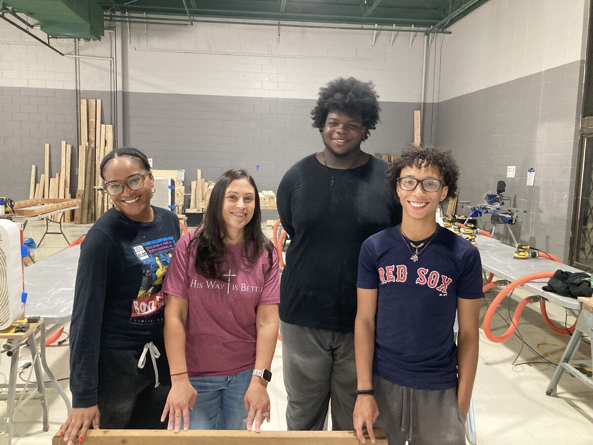 Alumna Naisha Richemond, Teacher Monica Strojny, Kyron Rodriguez, and Jonathen Fortes posing together at the workshop.