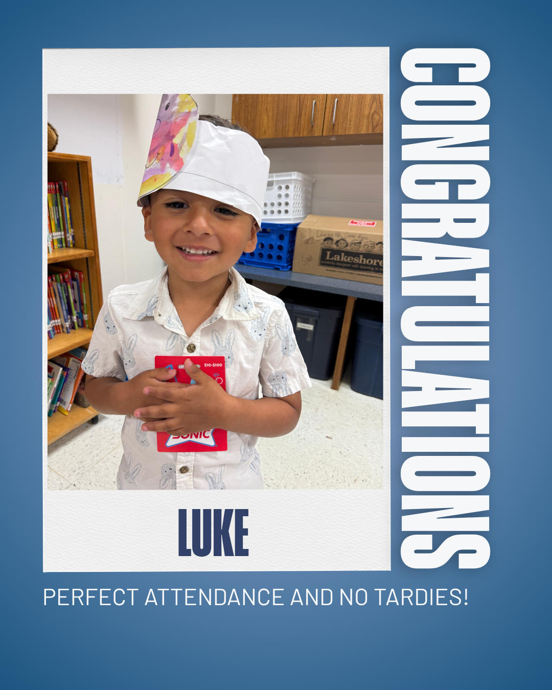 A smiling boy named Luke wears a paper chef's hat and holds a red gift card, celebrating perfect attendance.
