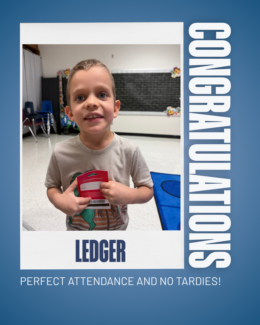 A young boy proudly holds a gift card, celebrating perfect attendance and no tardies.