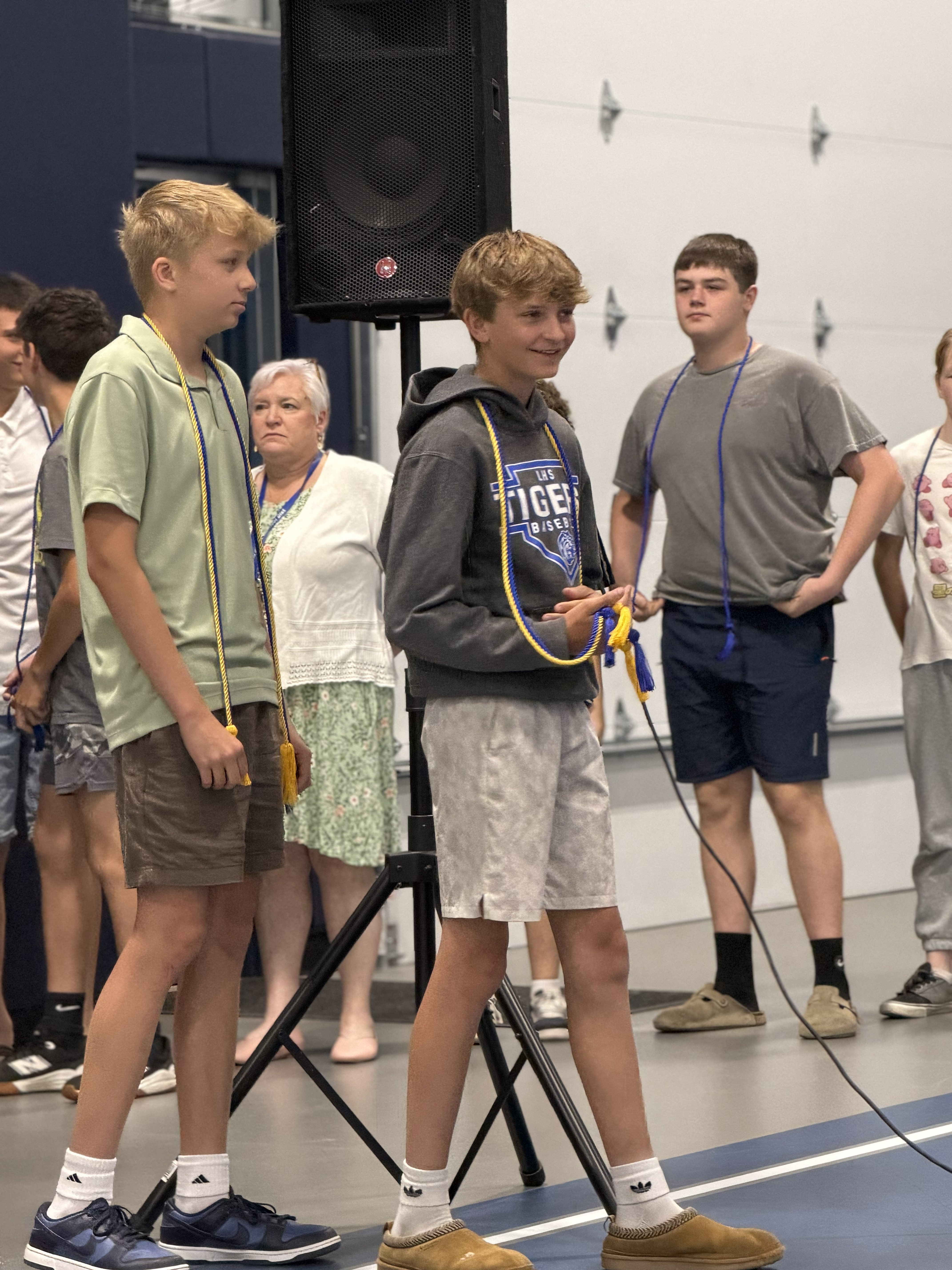 students in line wearing cords with shorts and tshirts