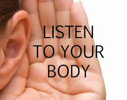 Close-up of a person cupping their ear with text 'LISTEN TO YOUR BODY'.