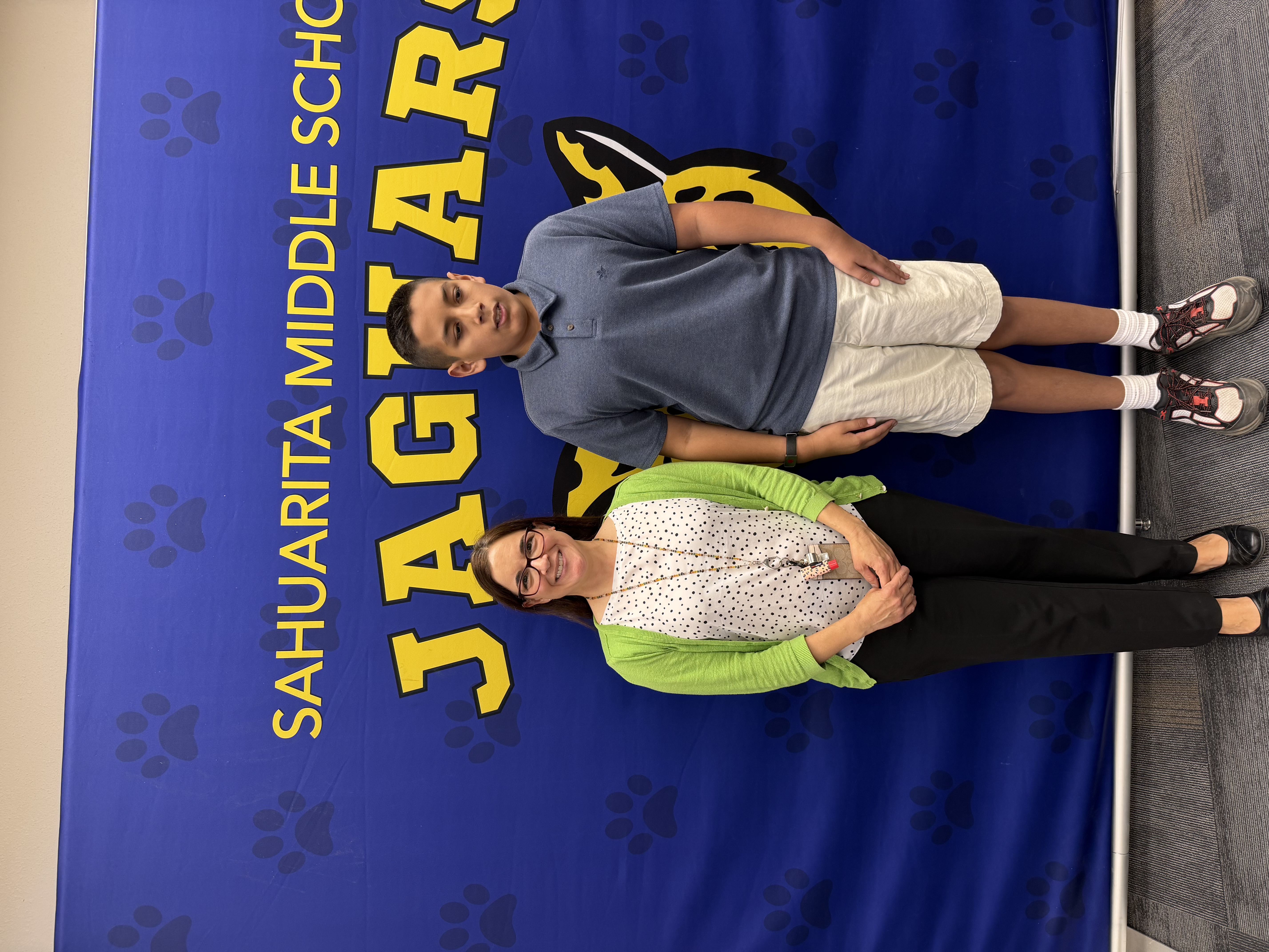 Picture of student and principal with backdrop