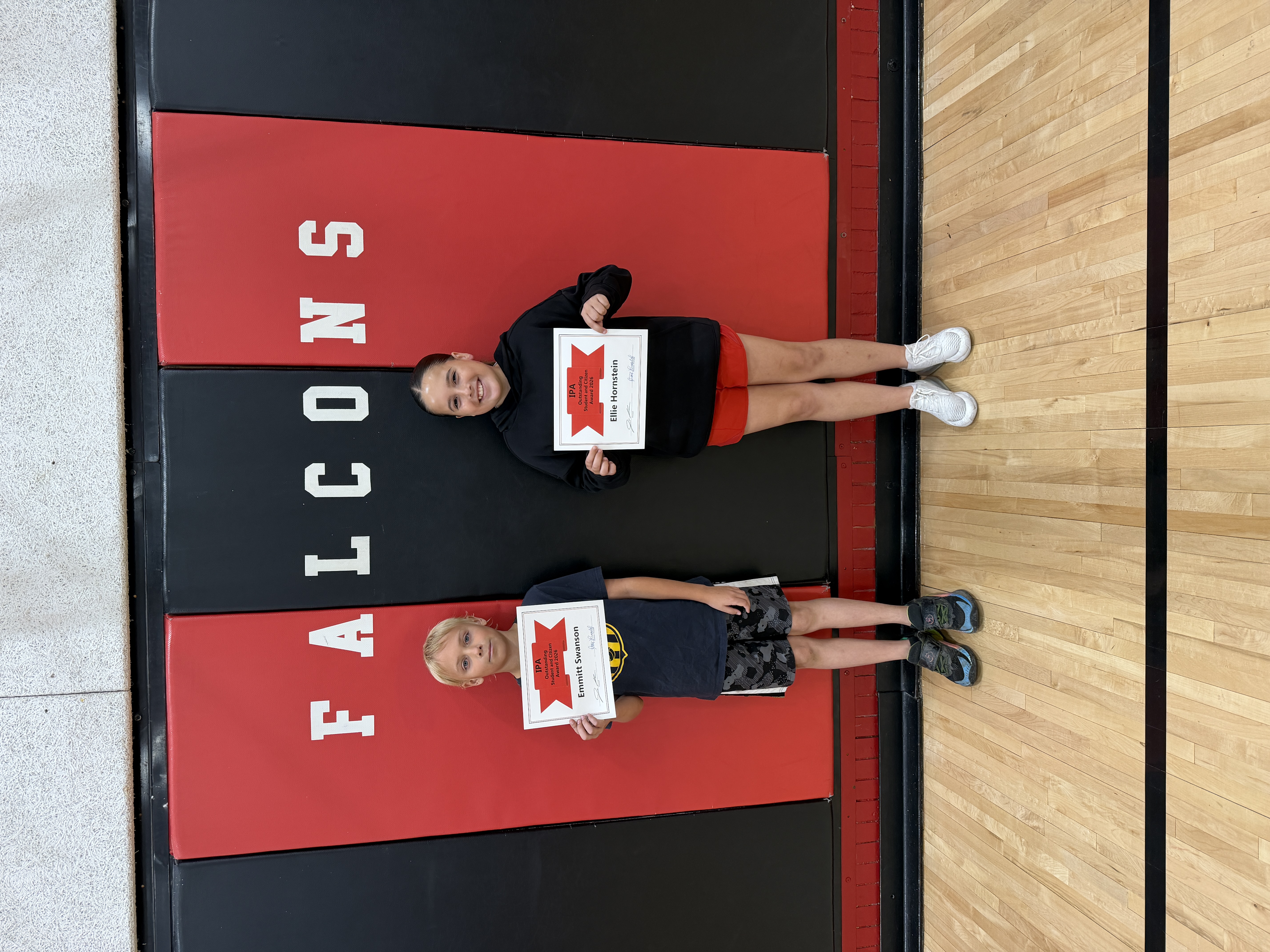 Two students, Ellie Hornstein and Emmitt Swanson, proudly hold their IPA Outstanding Student and Citizen Awards.