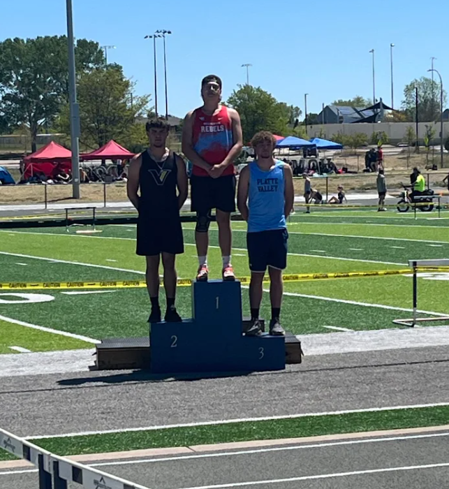 Zachary standing at the top of the podium for discus