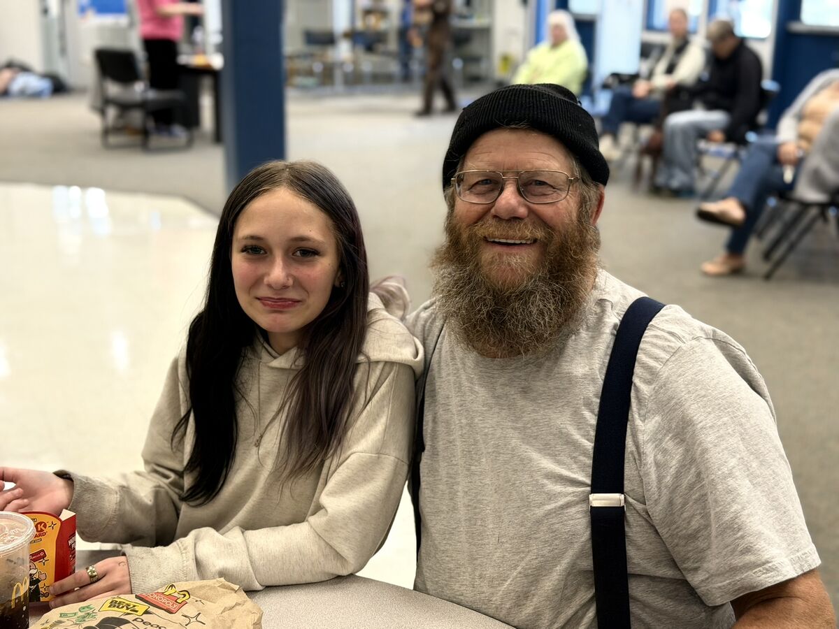 student and adult at lunch