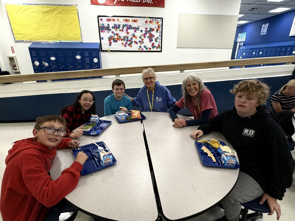 students and adults eating lunch