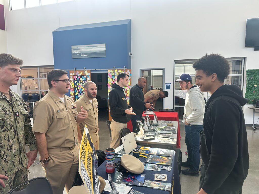 Students visited tables with four branches of the military.
