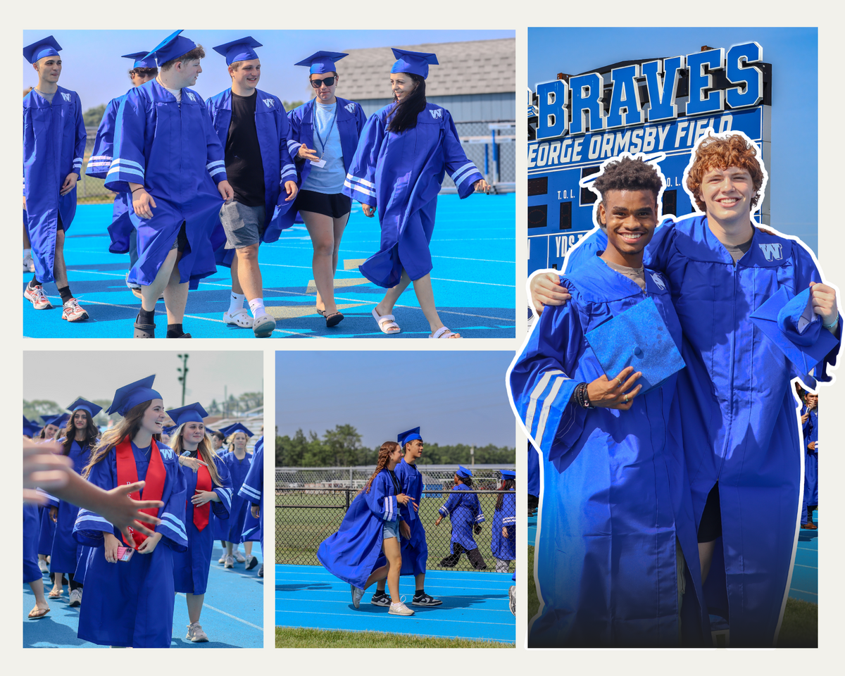 Graduates in blue gowns and caps walk on a blue track, with a "BRAVES" scoreboard in the background.