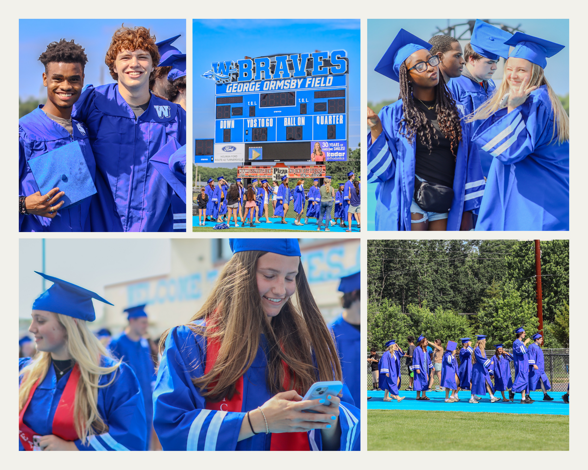 Two smiling graduates in blue gowns and caps pose for a photo.