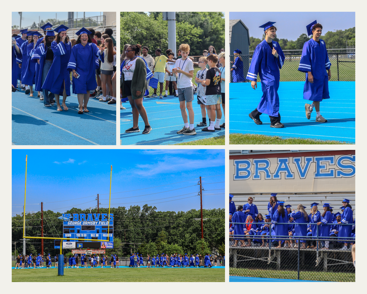 Graduates in blue gowns and caps walk on a blue track, some smiling and laughing.