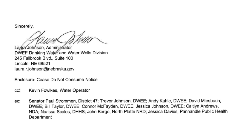 A close-up of a document ending with a signature by Laura Johnson, Administrator of the DWEE Drinking Water and Water Wells Division.