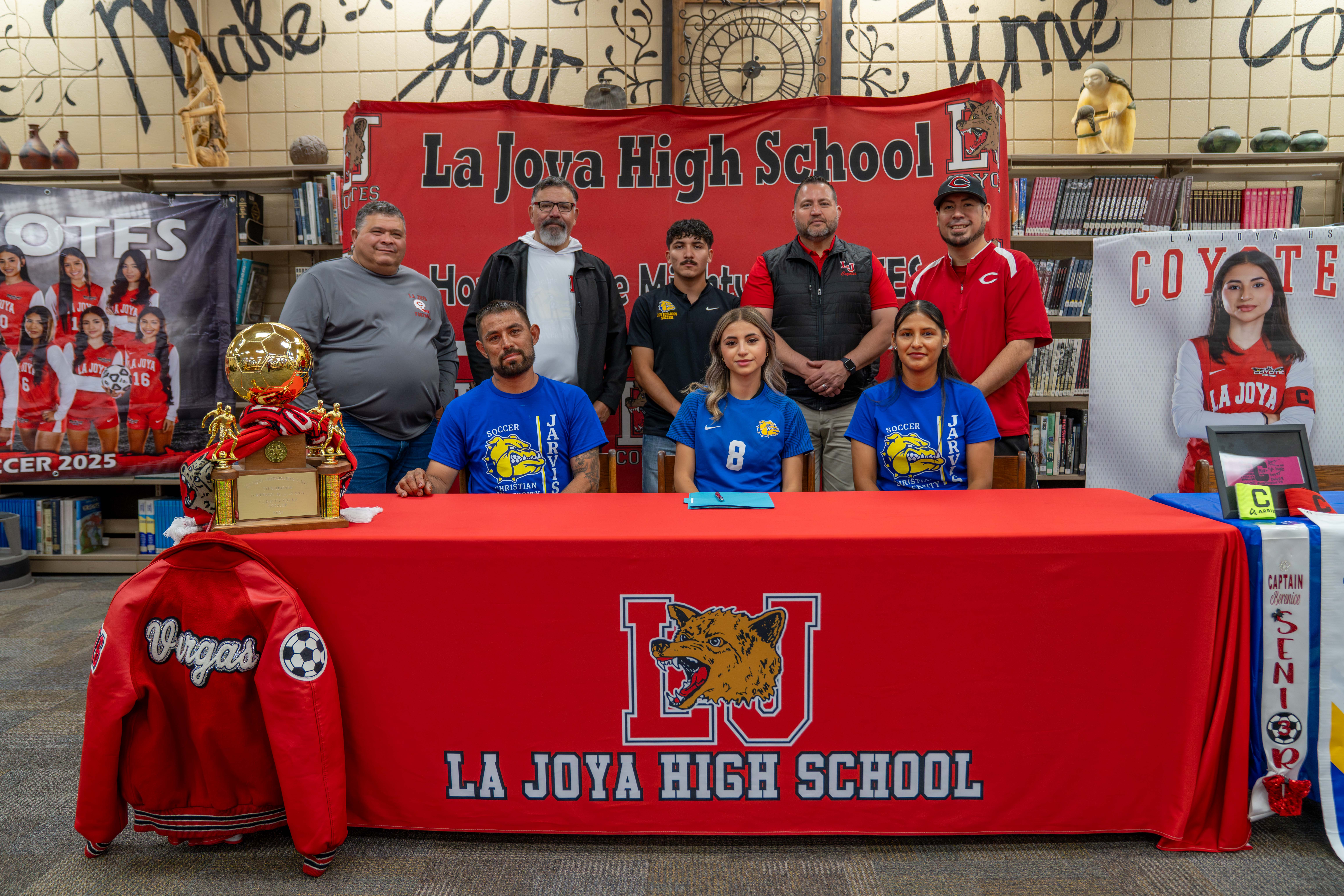 La Joya High School students sign letters of commitment with coaches and family present.
