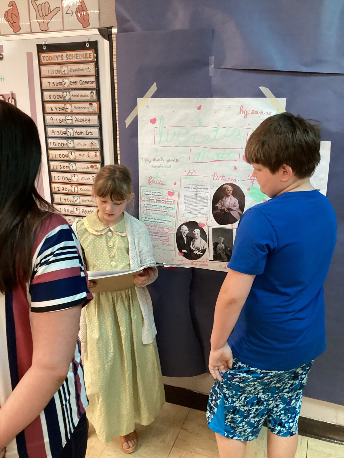 Students present a project about Lucretia Mott, featuring facts and pictures.
