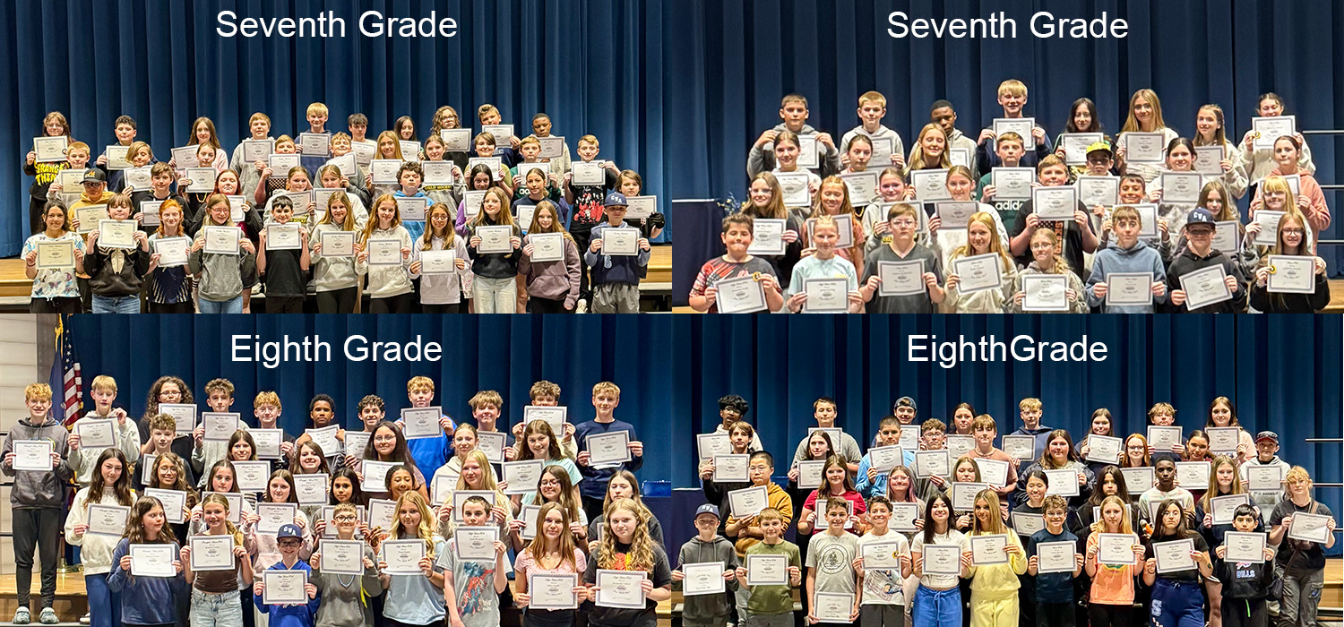 Students in seventh and eighth grade proudly hold certificates on stage.