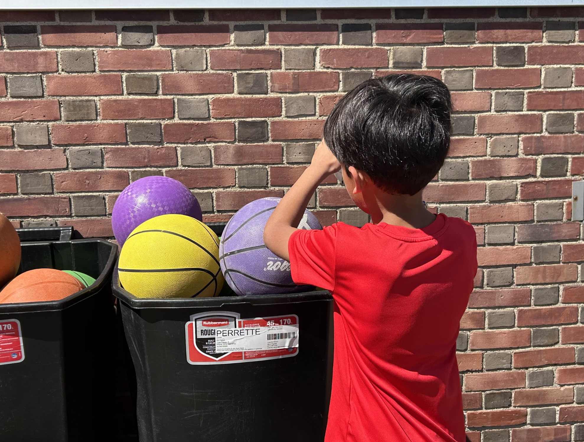 Student putting ball away after recess