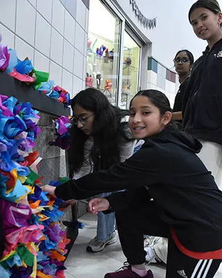 Davis students working on their collective canvas project in the hallway.