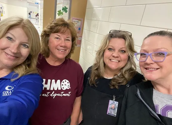 WHS Staff posing for a selfie in a hallway