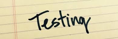 The word 'Testing' is handwritten in black ink on lined yellow paper.